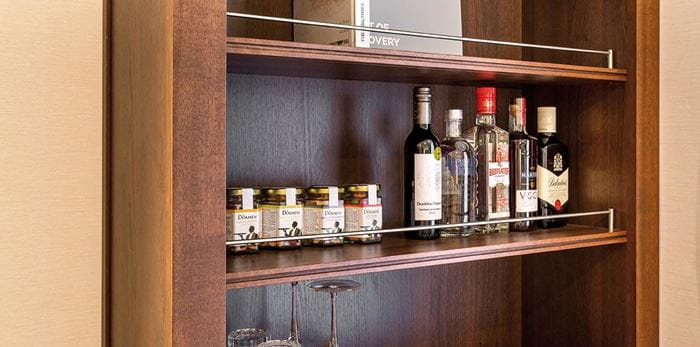 A selection of alcoholic drinks and snacks in an Adapted Junior Suite on Spirit of Discovery